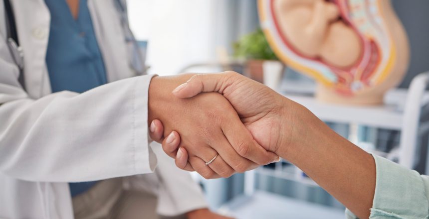 Pregnancy patient, doctor and gynecologist handshake for welcome, thank you and hello greeting. Pregnant maternity consultation, gynecology and woman for medical, baby healthcare or hospital support.